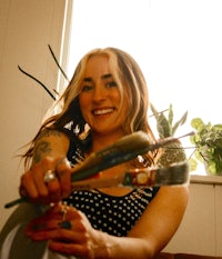 a woman holding a paint brush